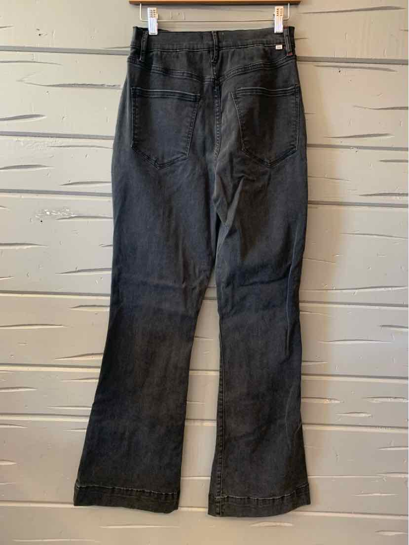Black denim jeans with a mid-rise waist and straight-leg fit, suitable for casual tops and stylish boots.