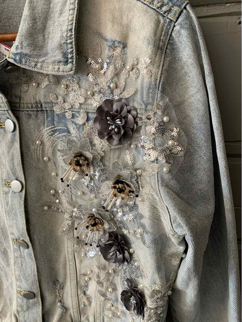 Light blue denim jacket with 3D floral appliques and pearls on front and shoulder.