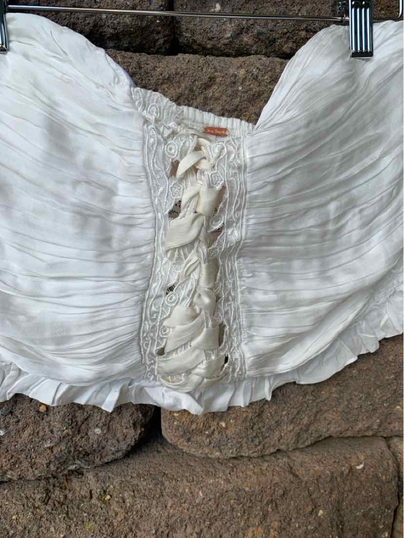 White strapless crop top with ruched fabric and lace-up front detail.