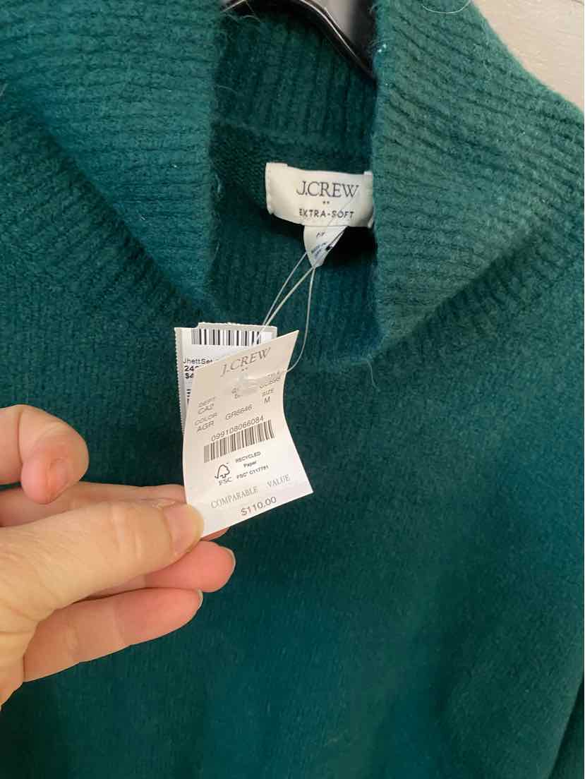 Green ribbed knit sweater with folded turtleneck collar and J.Crew label.