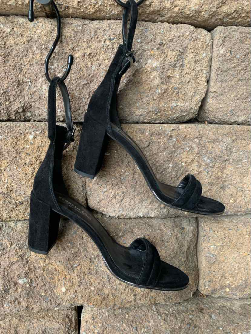 Black suede open-toe block heel sandals with ankle straps and square toe design.