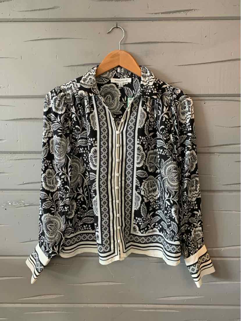 Black and white floral blouse with long sleeves, button-down front, and decorative vertical stripe detailing.