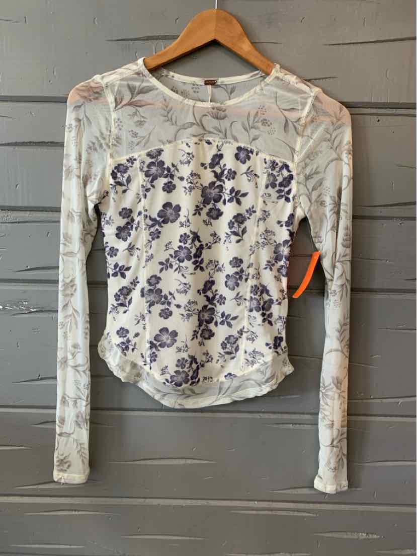 Long-sleeve white floral top with purple flowers, fitted silhouette, and crew neckline.