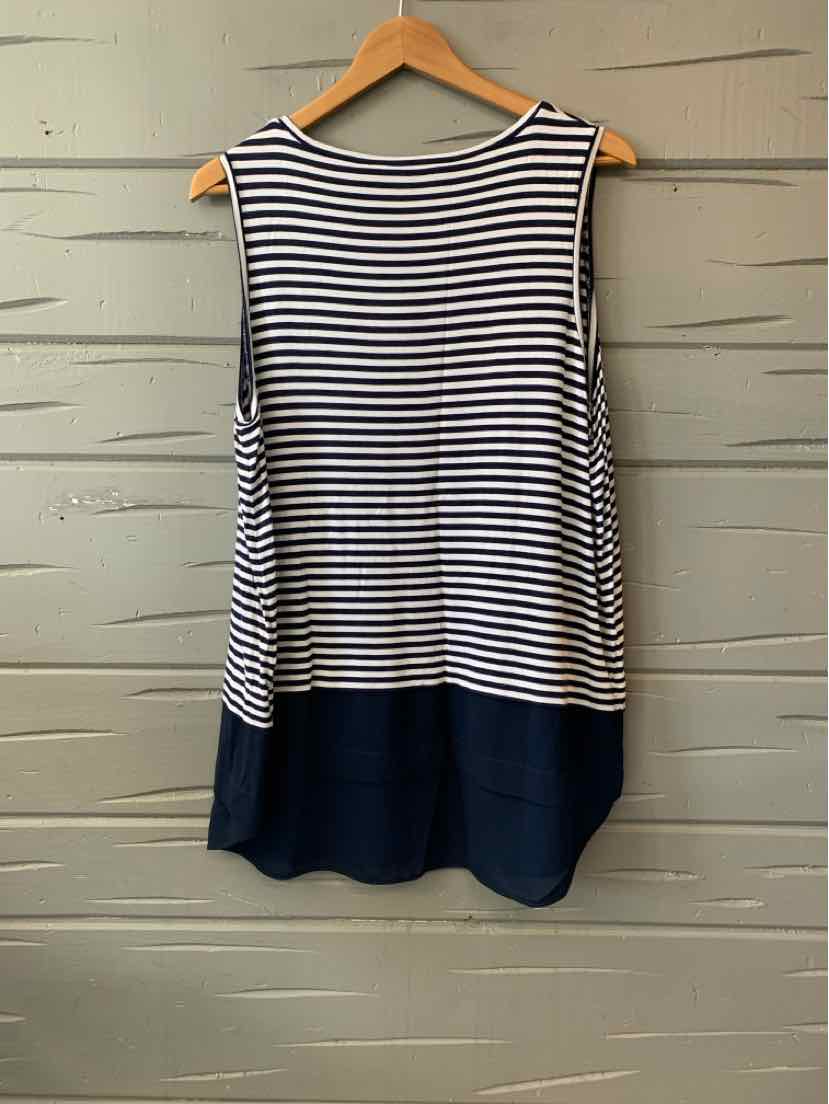 Sleeveless navy and white striped top with solid navy hem in size 1X hanging on wooden hanger.