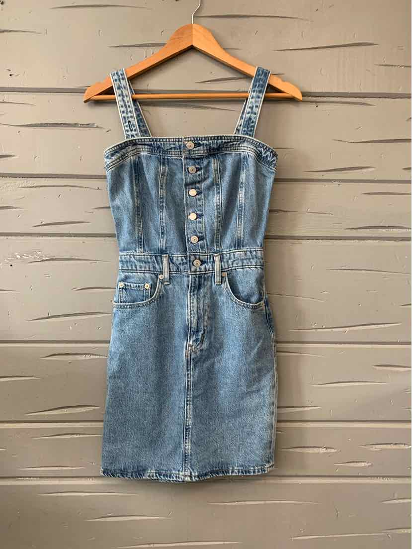 Blue denim button-front mini dress with adjustable straps and front pockets.