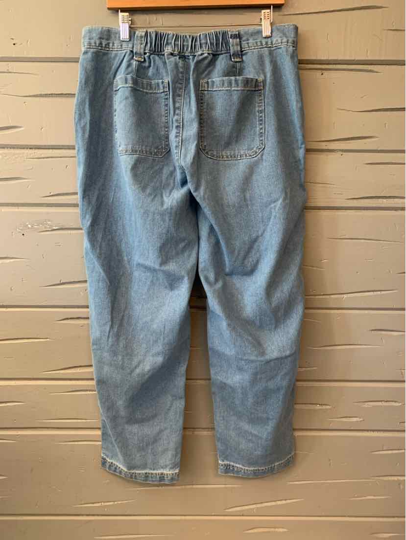 Light blue denim jeans with an elastic waistband and back pockets hanging on a wooden hanger.
