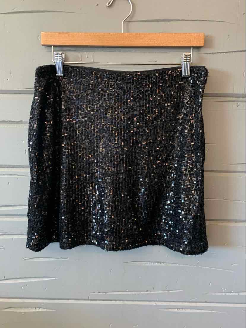 Black sequined mini skirt with subtle shimmer, perfect for pairing with women's dresses or casual tops.