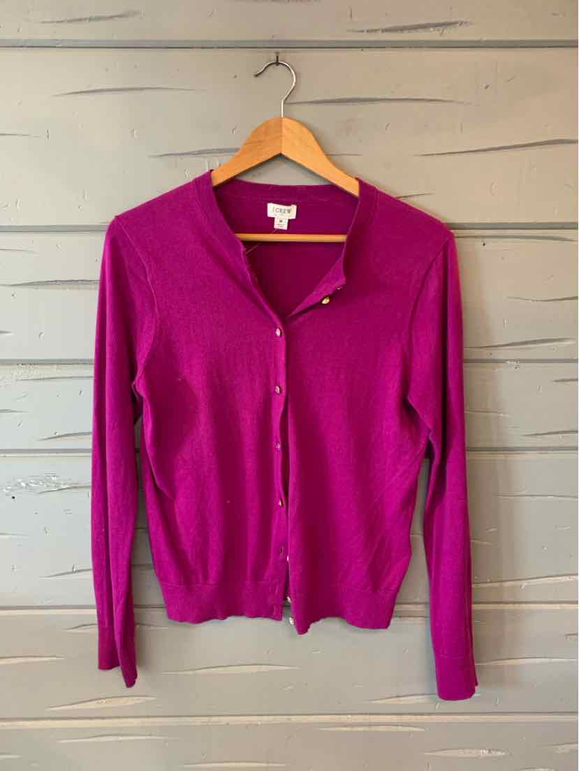 Magenta long-sleeve button-up cardigan with V-neck and ribbed cuffs on wooden hanger.