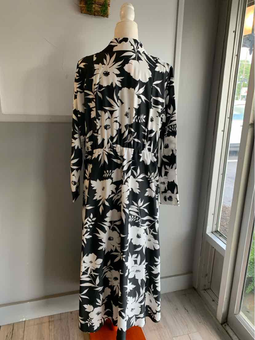Black long floral dress with white flower patterns and long sleeves, midi length.