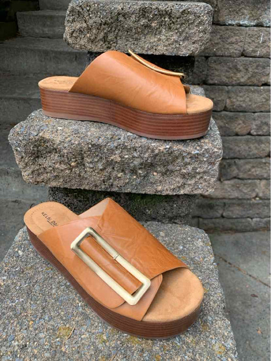 Tan leather platform sandals with open toe and wide strap featuring large gold buckle, size 8.5.