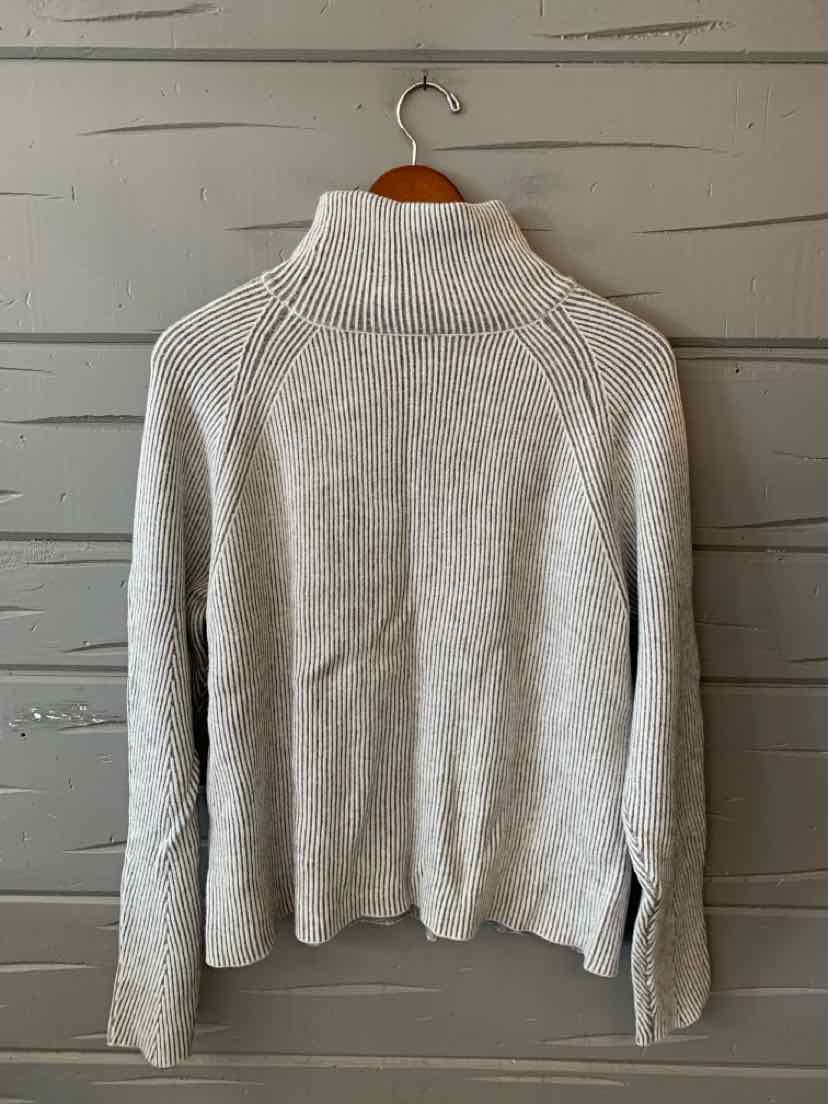 Light gray ribbed knit sweater with a high folded collar, long sleeves, and a relaxed fit.