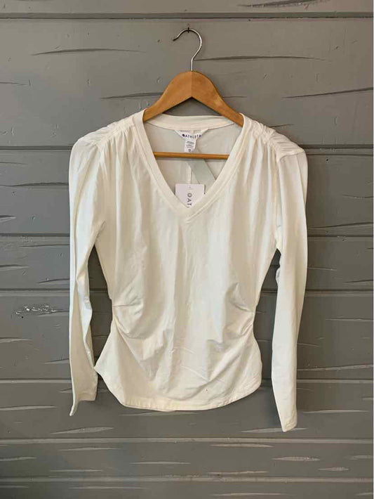 White long-sleeve V-neck fitted top with subtle ruching, size XS on wooden hanger.