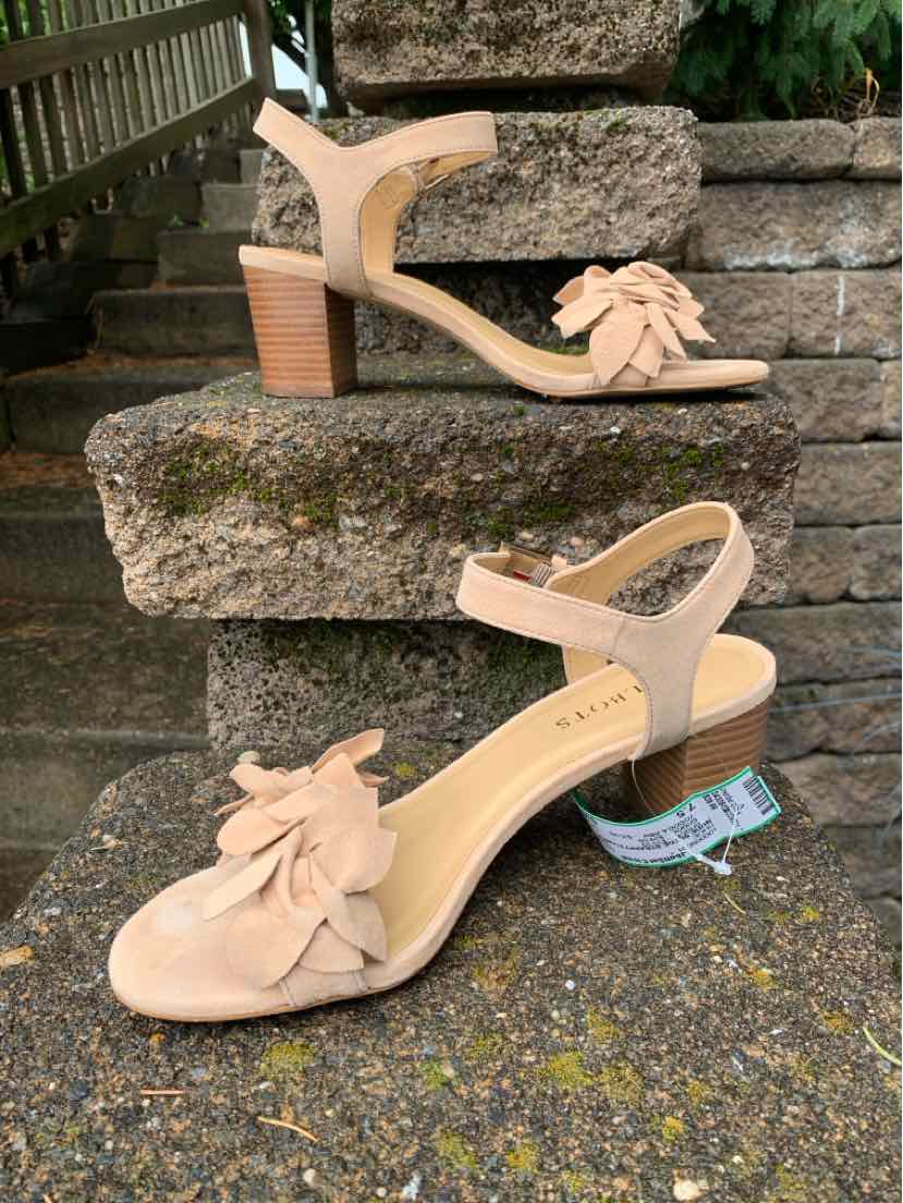 Nude suede heeled sandals with ankle strap and floral embellishment on toe, size 7.5.