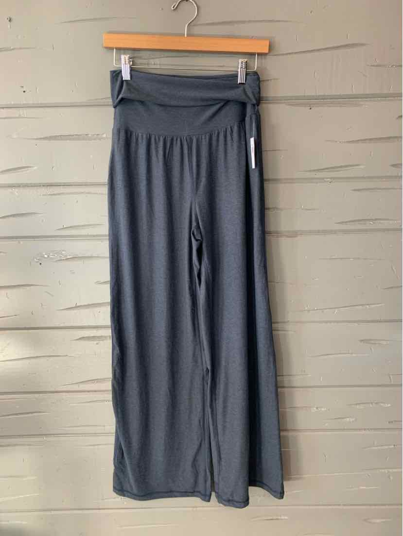 Dark gray wide-leg pants with an elastic waistband, hanging from a wooden clip hanger.
