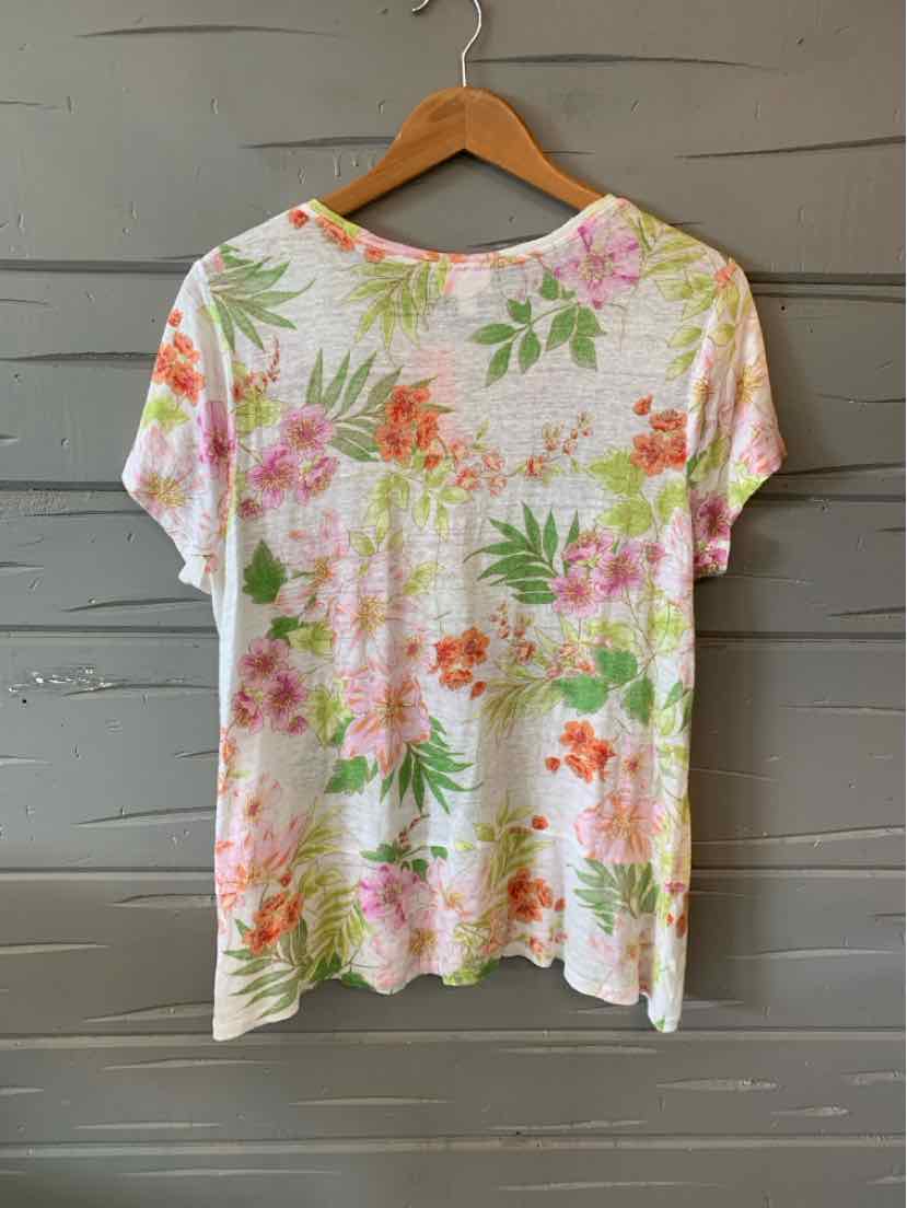 White short-sleeve blouse with pink and orange floral print and green leaves, lightweight fabric.