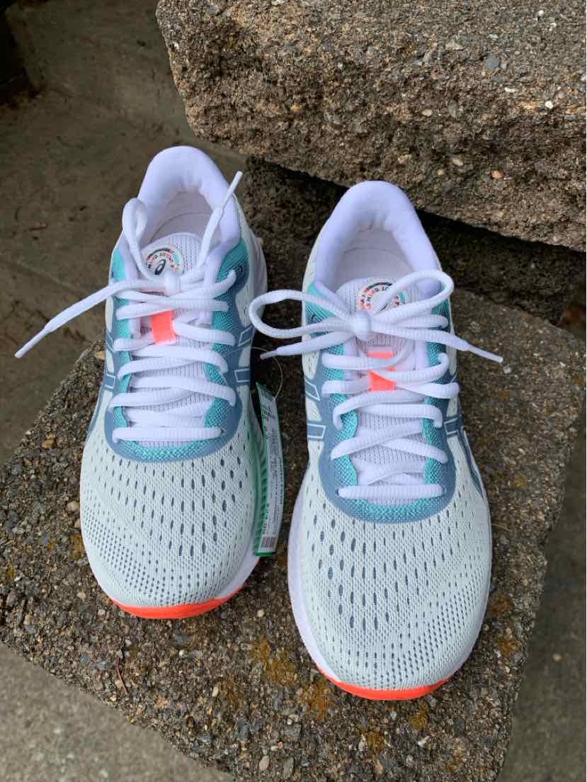 Light blue and white mesh ASICS sneakers with neon orange accents and white laces, size 6.5.
