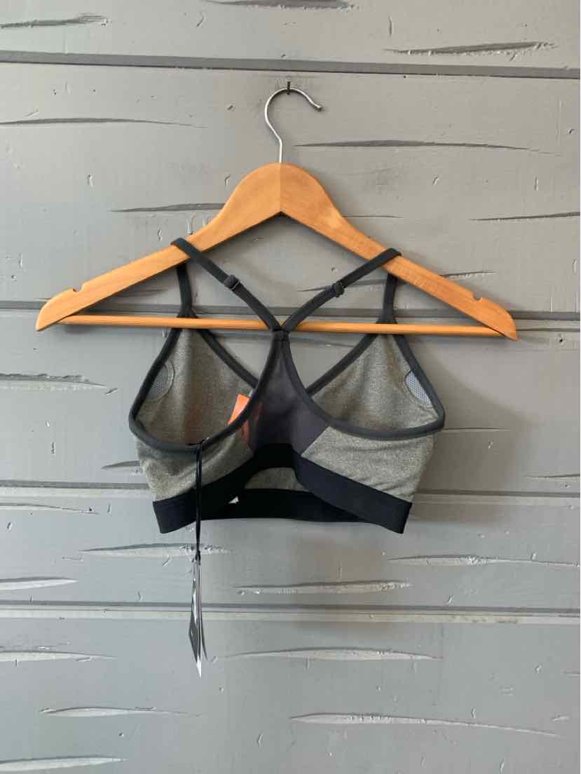 Gray and black Nike sports bra with thin straps and mesh paneling on the back.