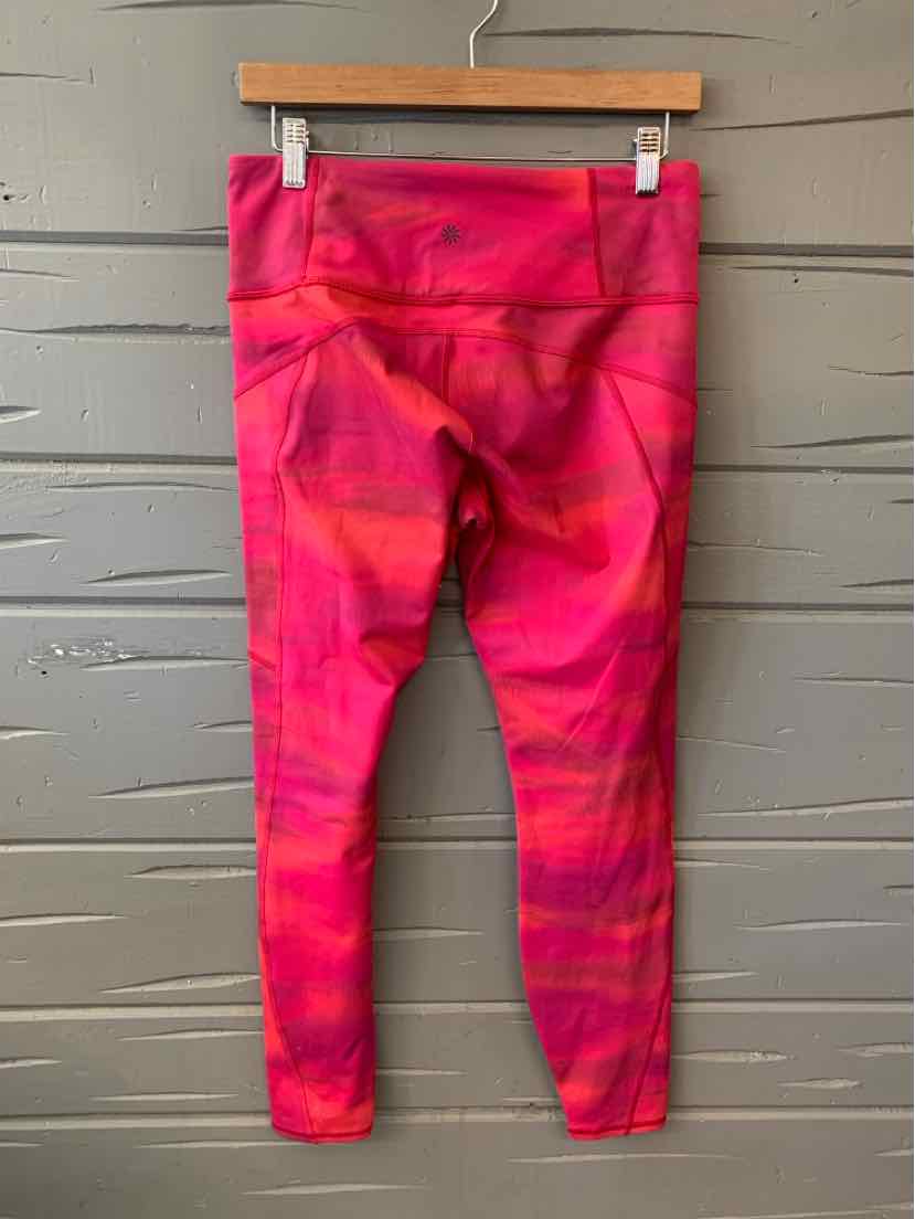 High-waist cropped leggings in vibrant pink and red abstract pattern with a smooth, stretchy fabric.