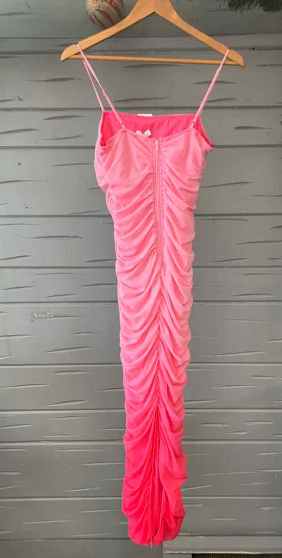 Pink ruched slip dress with thin straps and button detail on front.