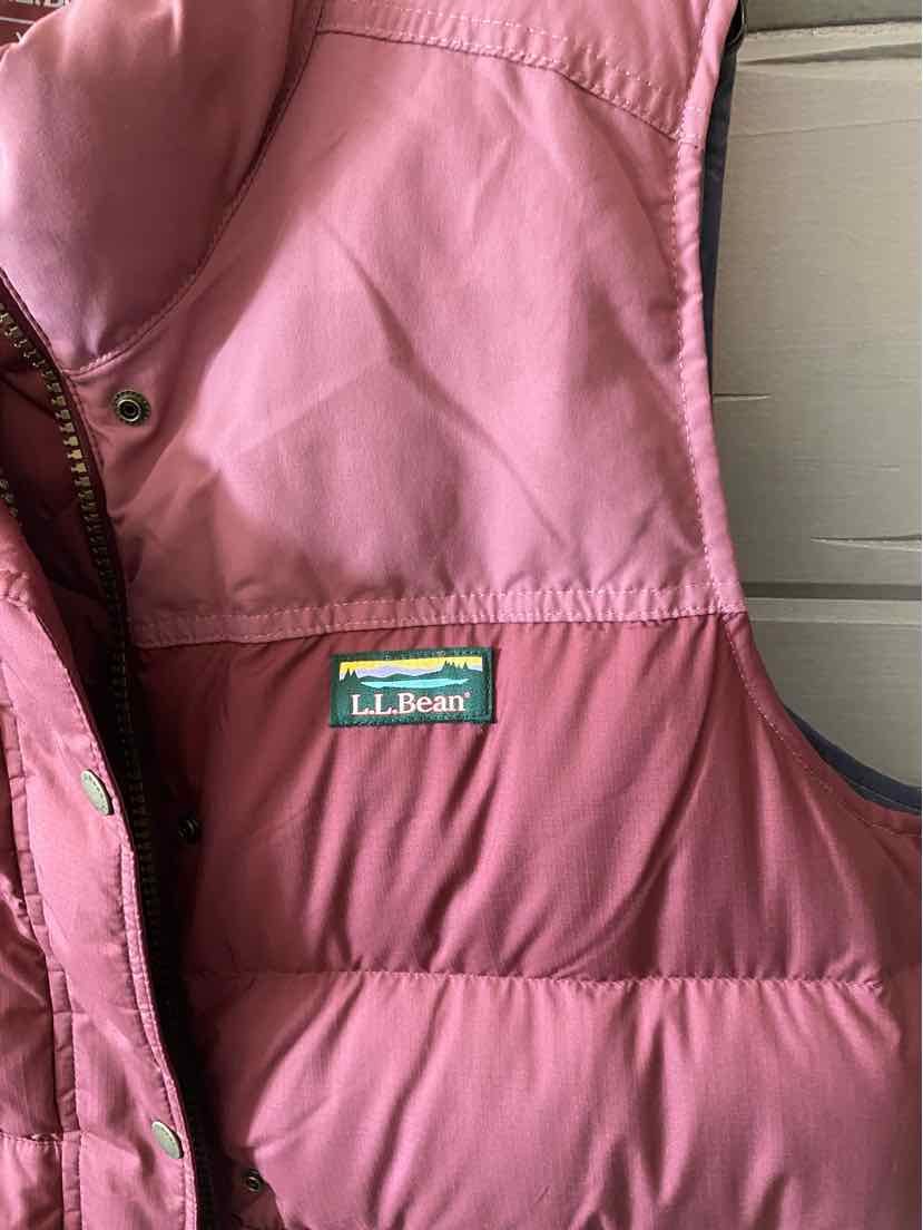 Pink puffer vest with quilted stitching and L.L.Bean logo patch on chest.