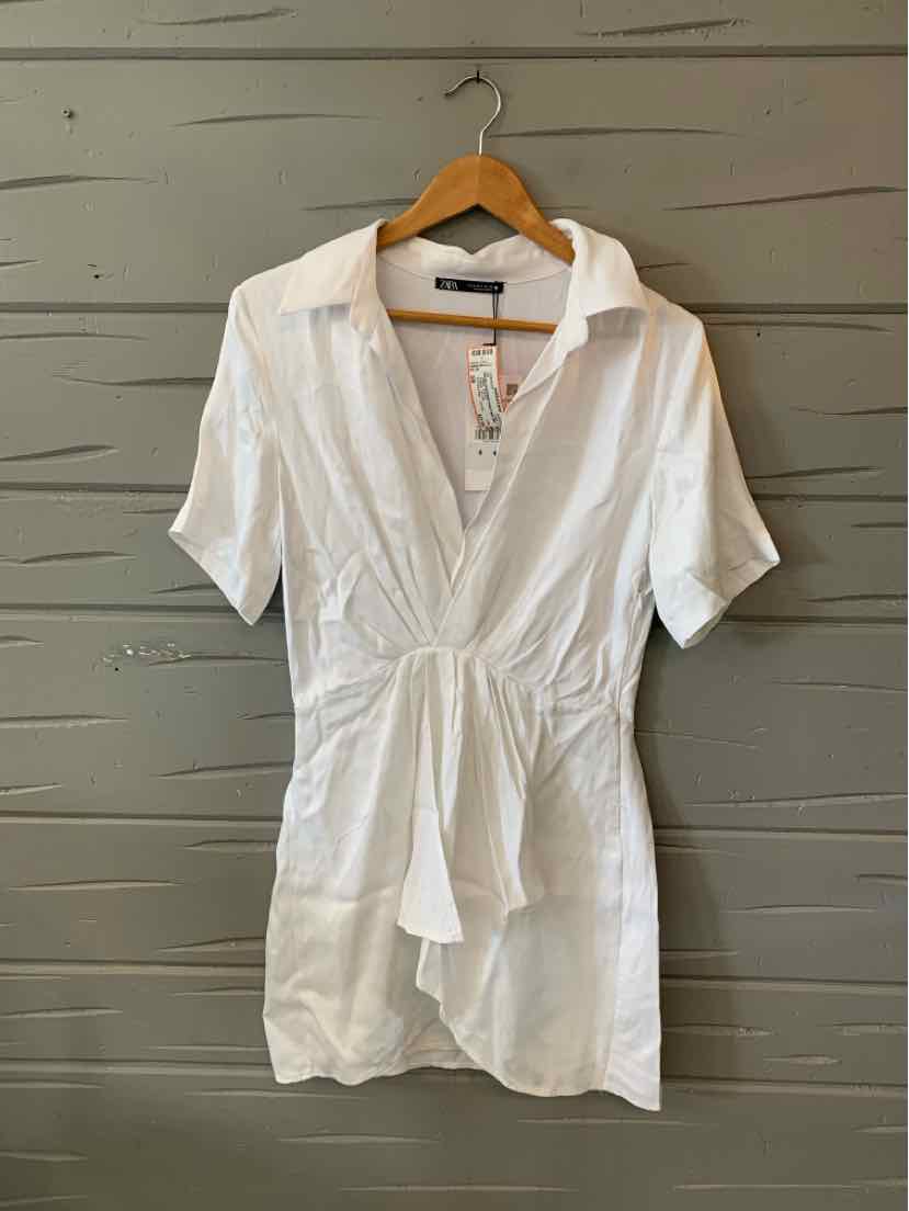 White short-sleeve dress with a deep V-neck, collar, and gathered waist tie detail.