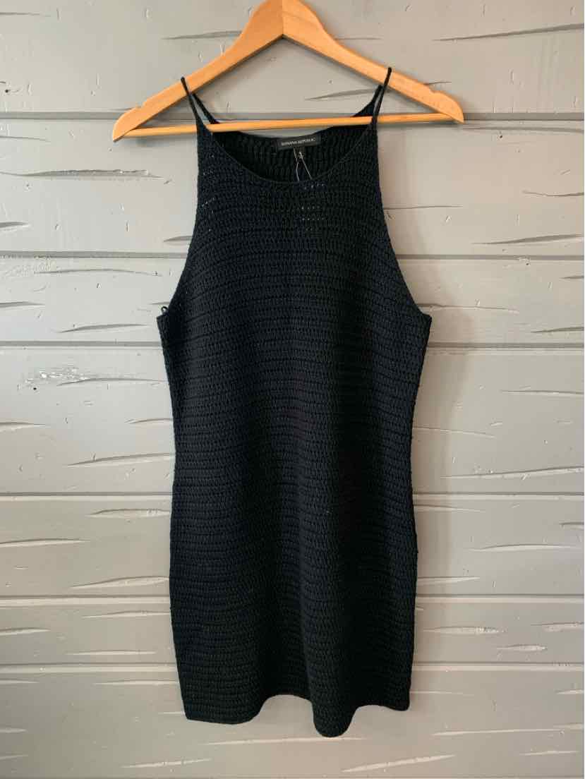 Black sleeveless ribbed knit dress with high neckline, medium size hanging on wooden hanger.
