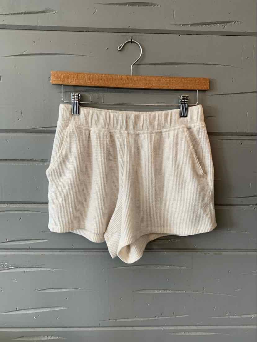 Light beige soft fabric casual shorts with elastic waistband and side pockets, size XS.