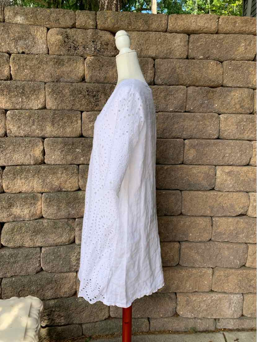 White knee-length dress with eyelet fabric, 3/4 sleeves, and scalloped hem.