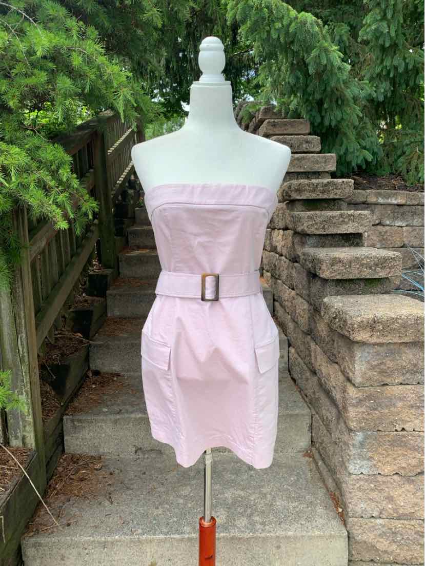 Light pink strapless dress with pleated skirt and matching belt on white mannequin.