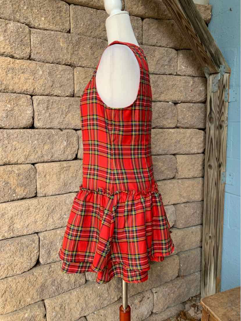 Red plaid sleeveless dress with a white rounded collar, fitted bodice, and flared ruffled skirt.