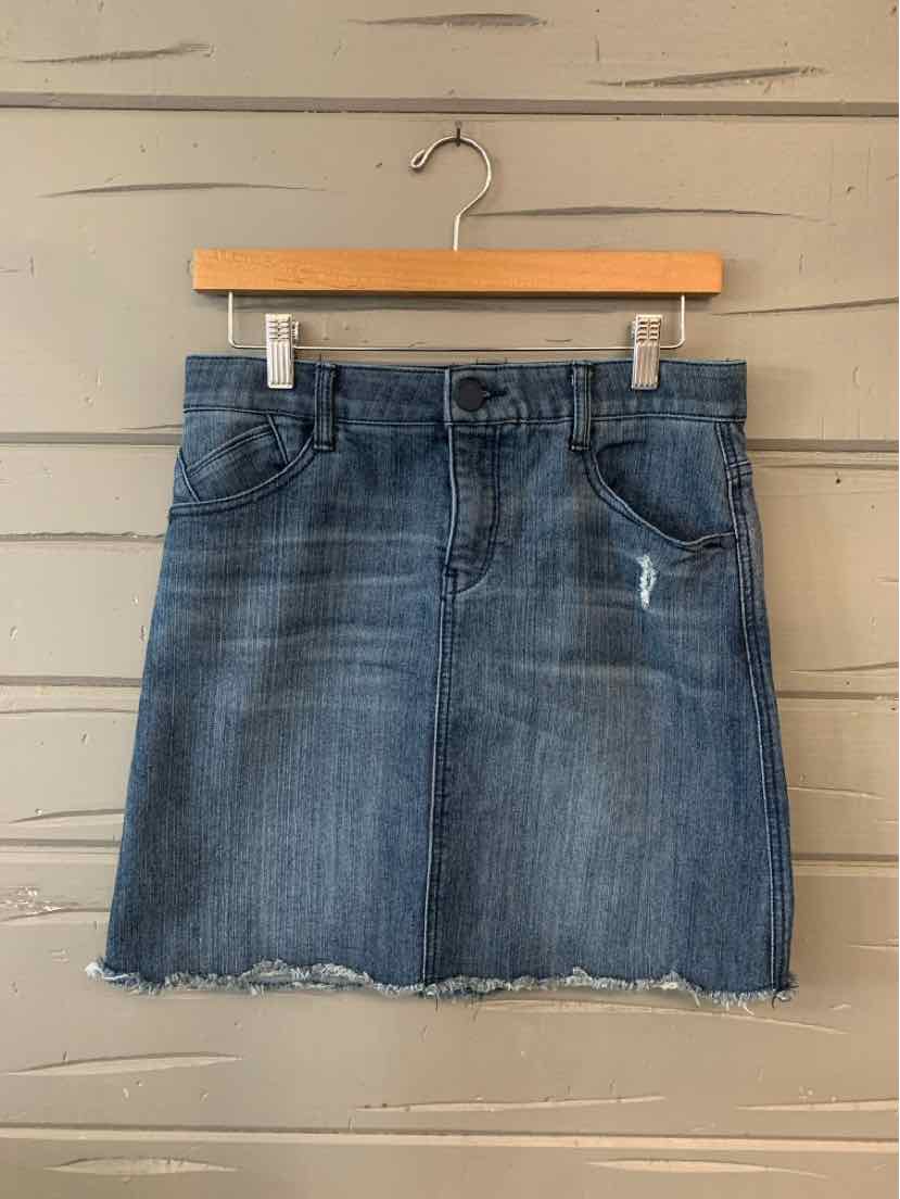 Blue denim mini skirt with front pockets and frayed hem on wooden hanger.