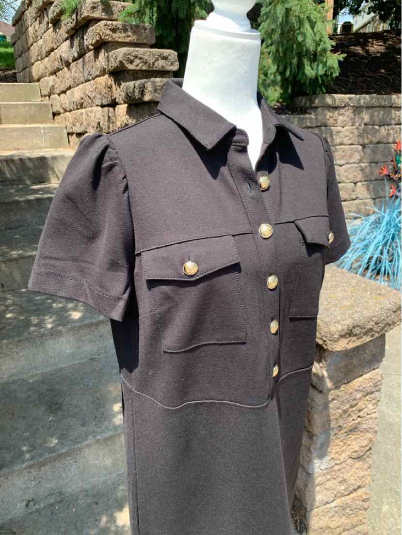 Black short-sleeve button-up dress with collar, puffed shoulders, and four front flap pockets.