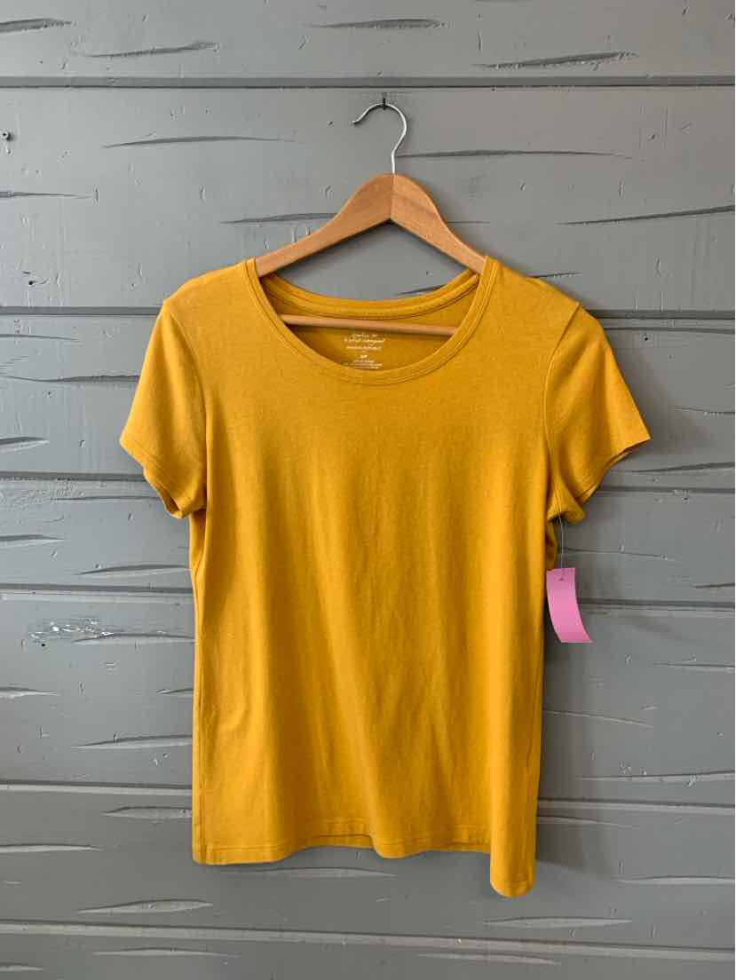 Yellow short-sleeve crew neck women's t-shirt on wooden hanger against gray wood panel background.