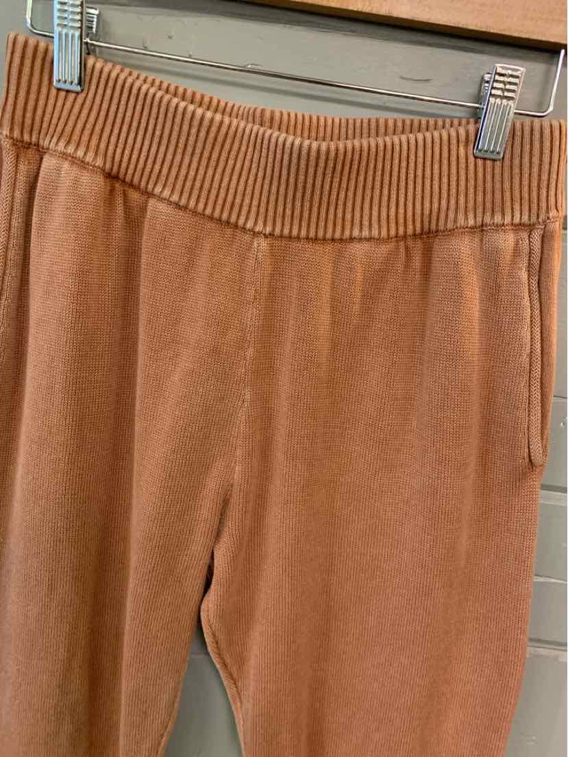 Tan soft fabric pants with ribbed elastic waistband and side pockets in size XS.