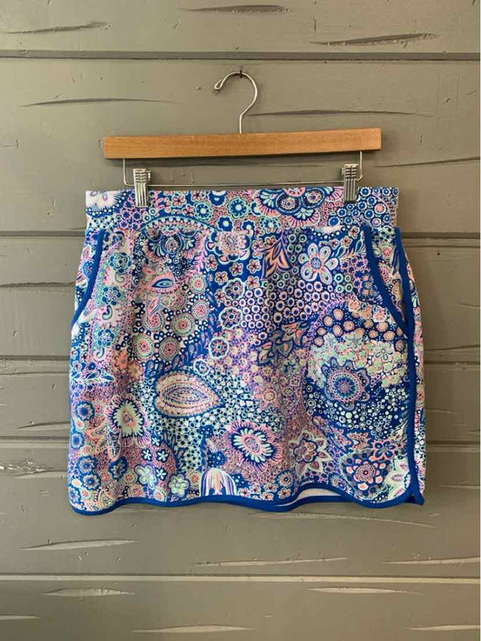 Blue floral print skirt with pink and white accents, side pockets, and scalloped hem.