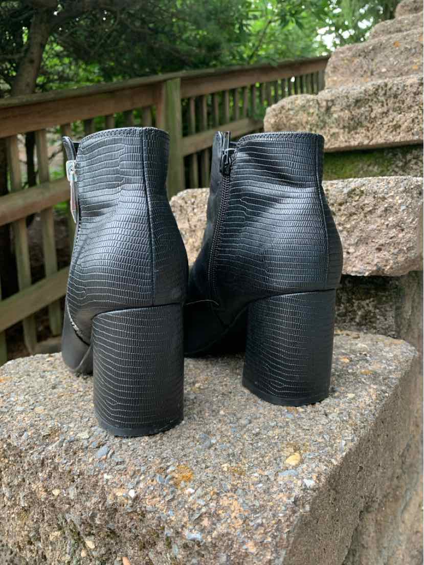 Black textured leather ankle boots with block heels and side zipper closures.