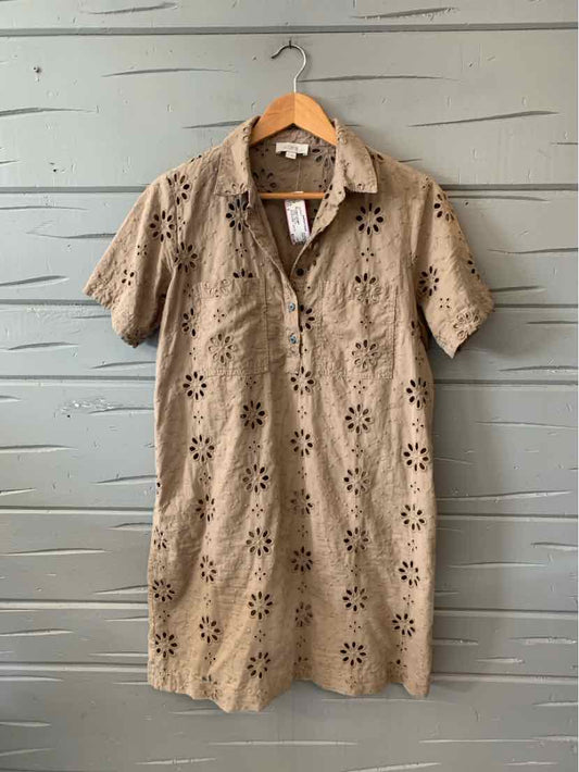 Beige short-sleeve polo dress with eyelet floral cutouts and front button placket, size 6.
