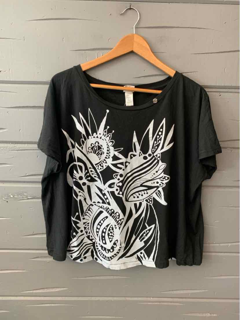 Black long-sleeve top with wide scoop neckline and bold white abstract floral graphic on front.