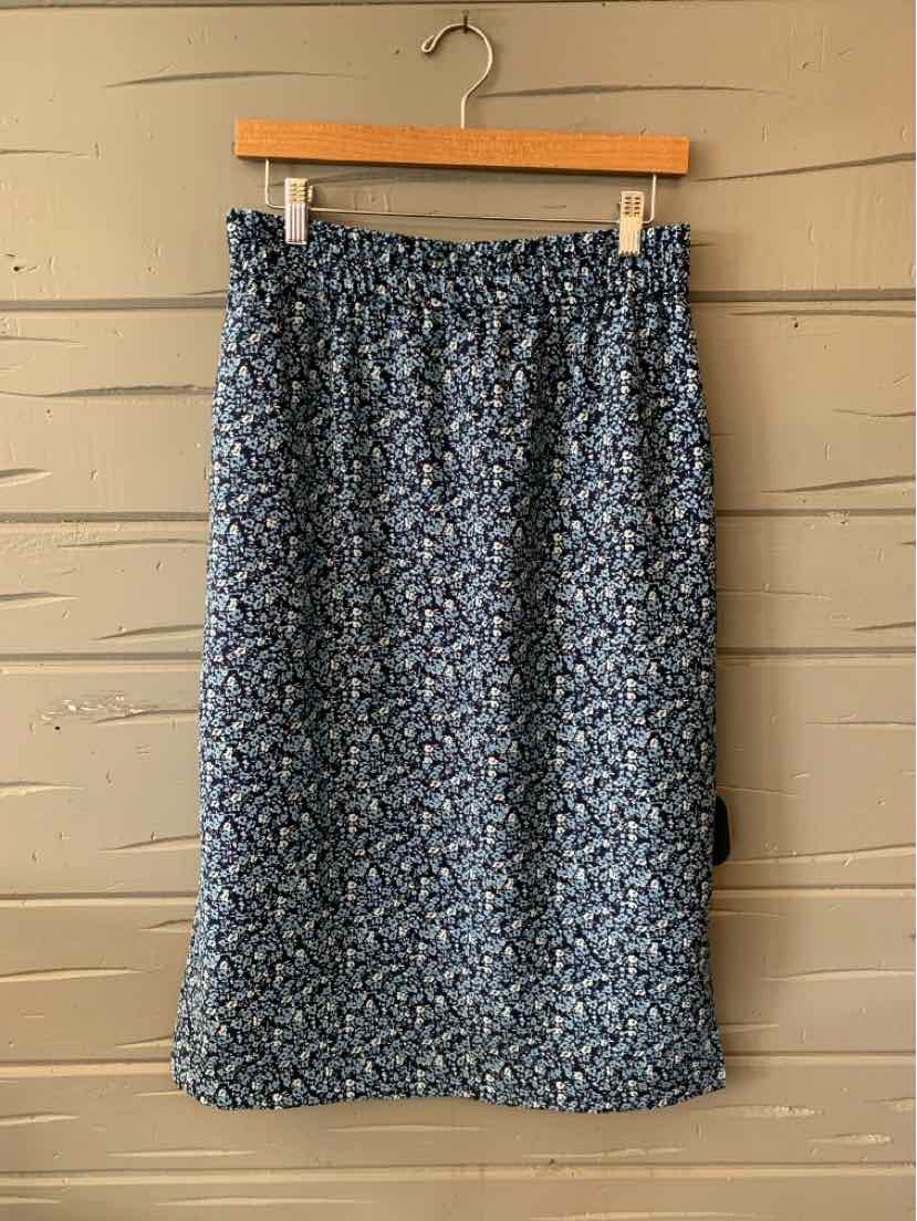 Navy blue floral midi skirt with gathered elastic waistband and soft fabric texture.