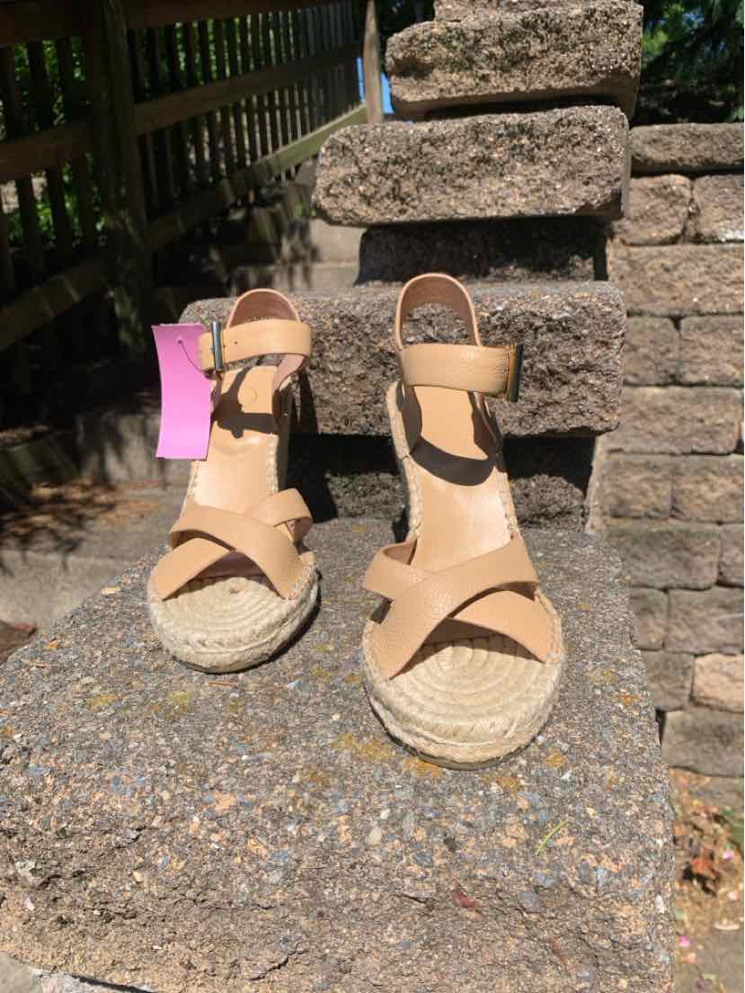 Tan leather wedge sandals with ankle straps and braided jute platform soles, size 7.