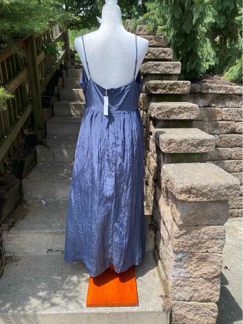 Navy blue satin spaghetti strap maxi dress with open back and tie detail at waist.