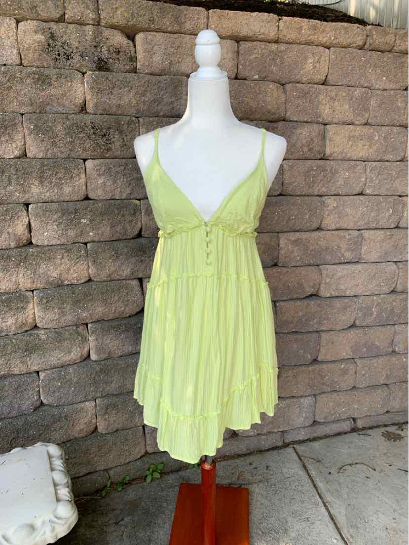 Light green sleeveless dress with thin straps, V-neckline, and gathered waist detailing.