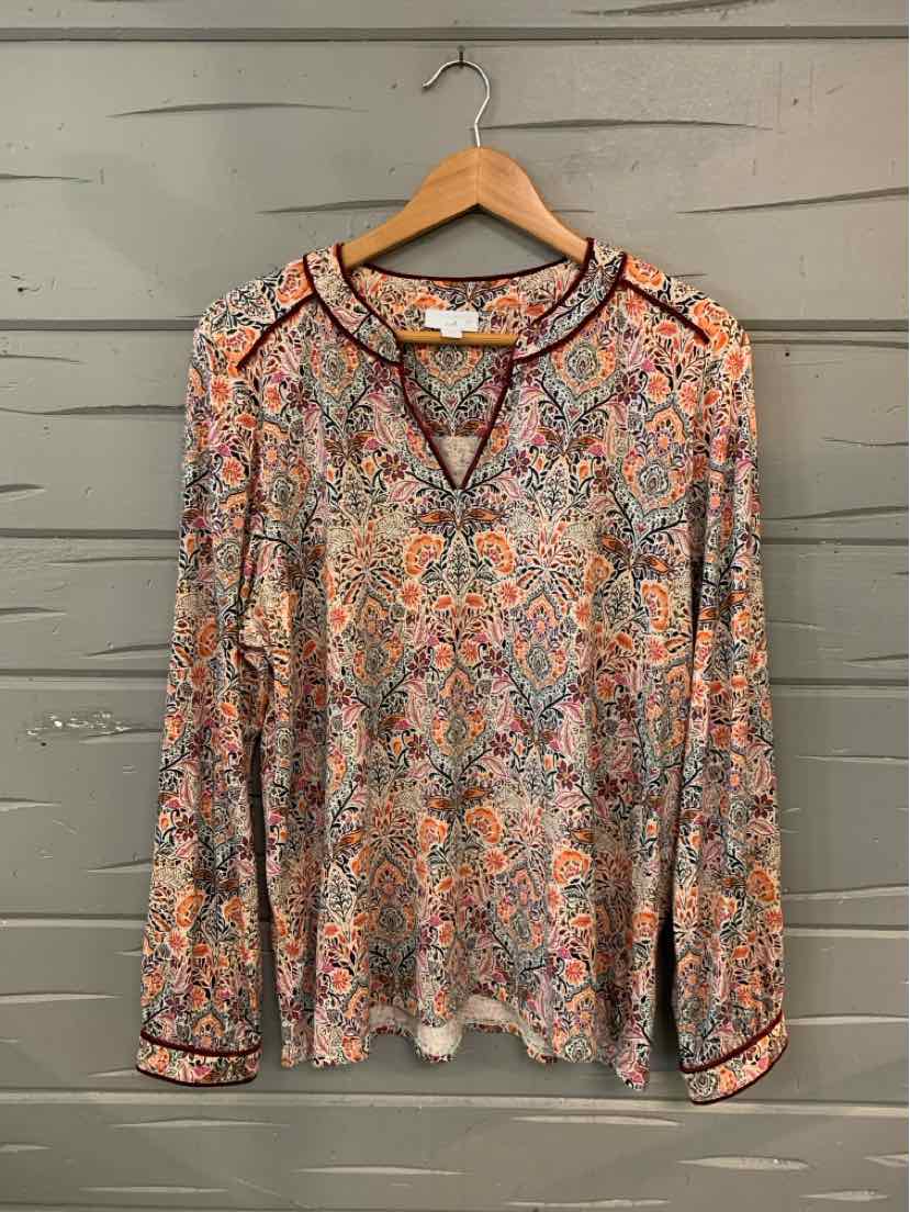 Long-sleeve blouse with multicolored paisley print, keyhole neckline, and black trim on cuffs and collar.