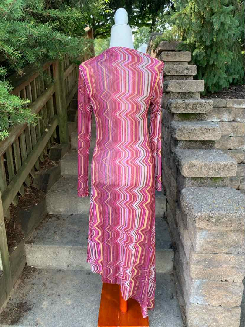 Long-sleeve fitted dress with pink, red, and white wavy stripe pattern and asymmetrical hem.
