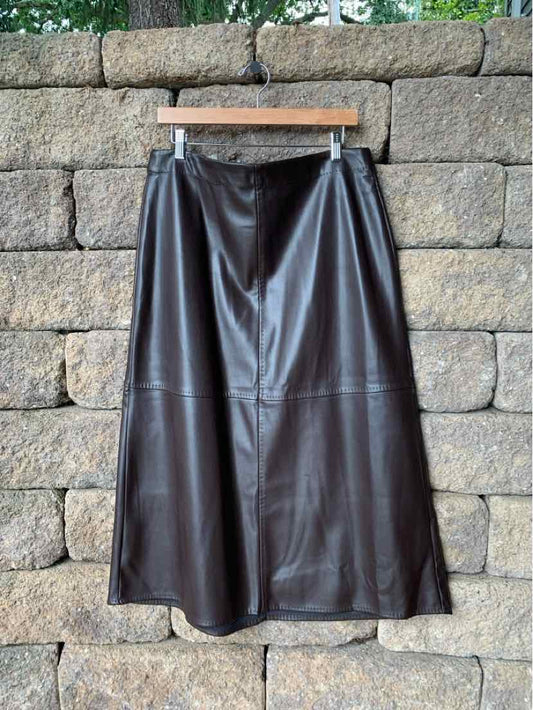 Black faux leather midi skirt with A-line shape and stitched panel detailing.