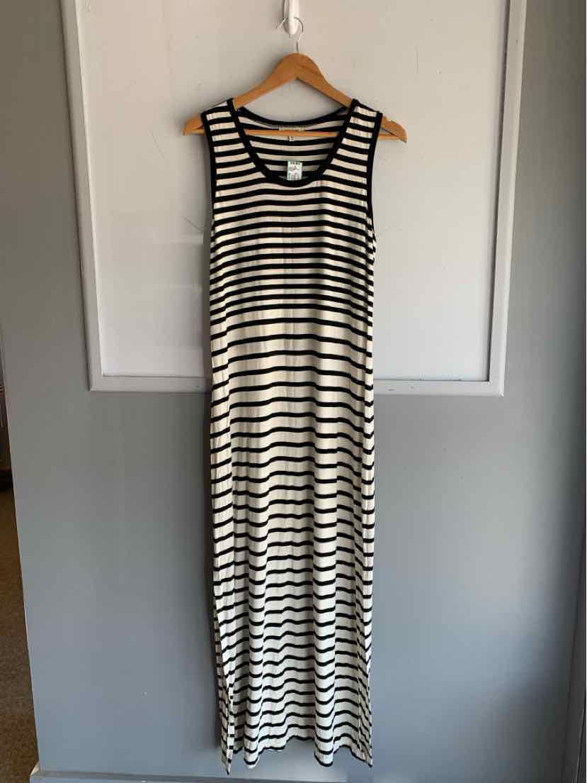 Black and white striped sleeveless maxi dress with scoop neckline hanging on wooden hanger.