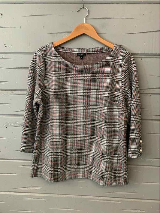 Gray and black houndstooth long-sleeve blouse with scoop neck and button cuffs.