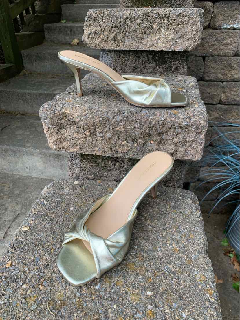 Metallic silver open-toe mule with twisted front strap and slender mid-height heel in size 8.5.