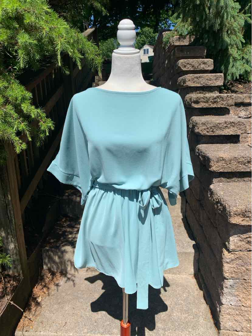 Teal short-sleeve dress with boat neckline and cinched waist belt on mannequin outdoors.