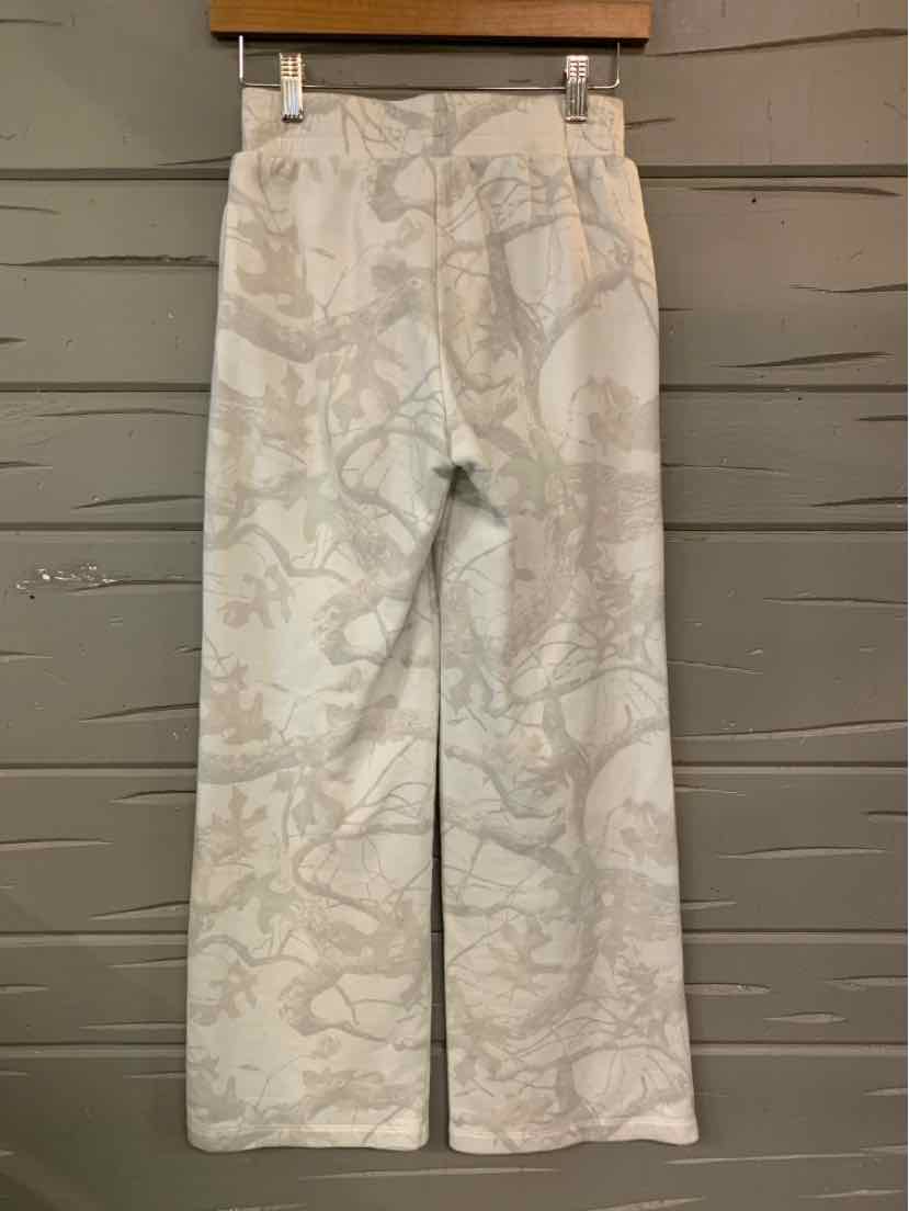 Light-colored wide-leg pants with subtle abstract floral pattern and elastic waistband.